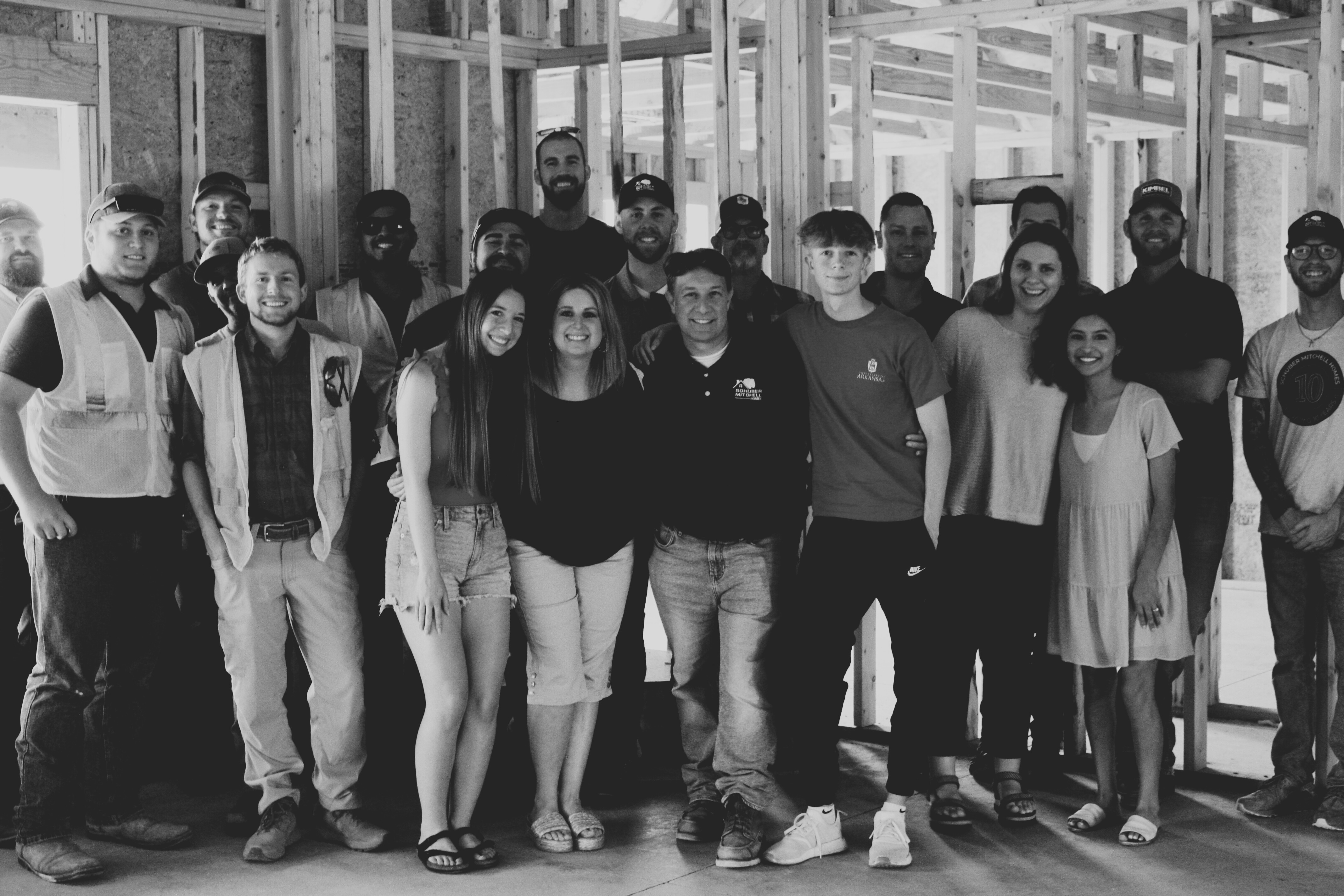 Group photo of the family, friends, and team celebrating the home’s framing dedication